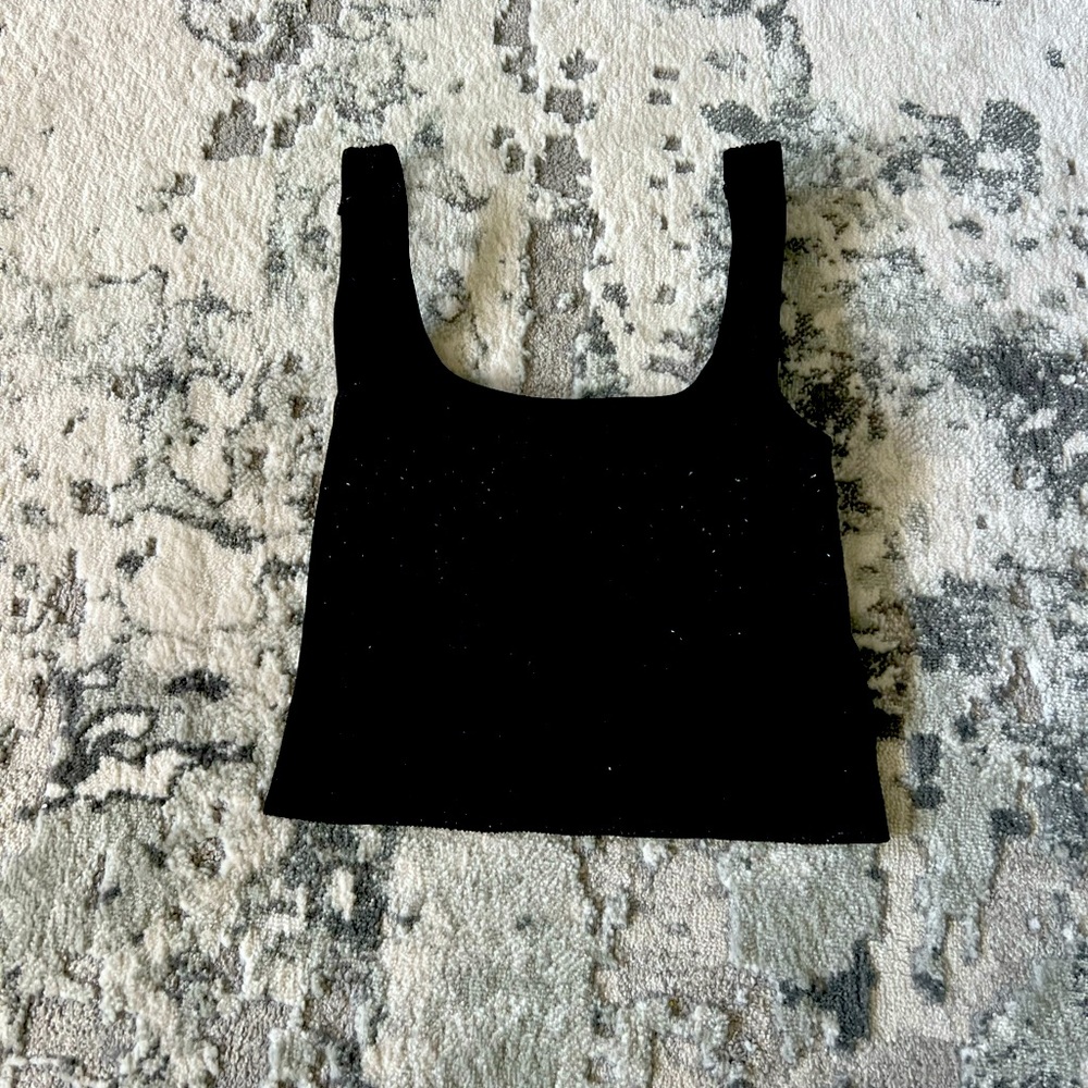 black fitted tank top from the brand “Dry Goods”